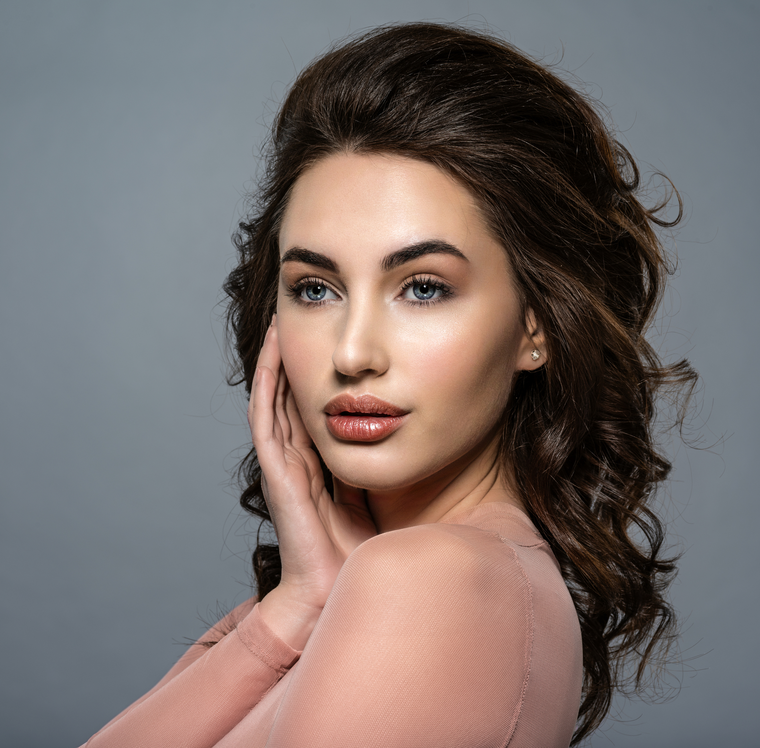 Elegant female patient after facial aesthetic procedure