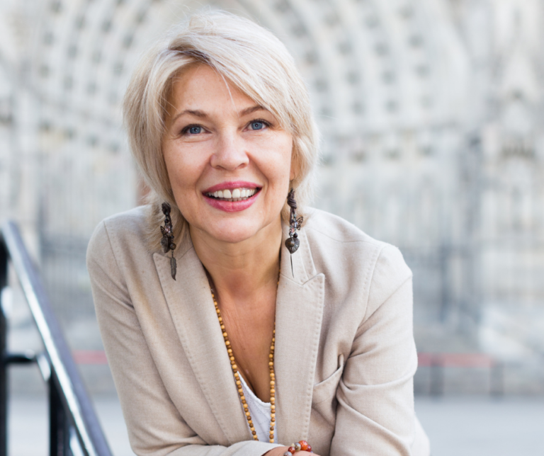 Confident mature woman smiling — considering facelift surgery abroad with Lunara Medical Travel